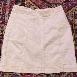 White skirt with hidden zipper closure , hangs above the knees.